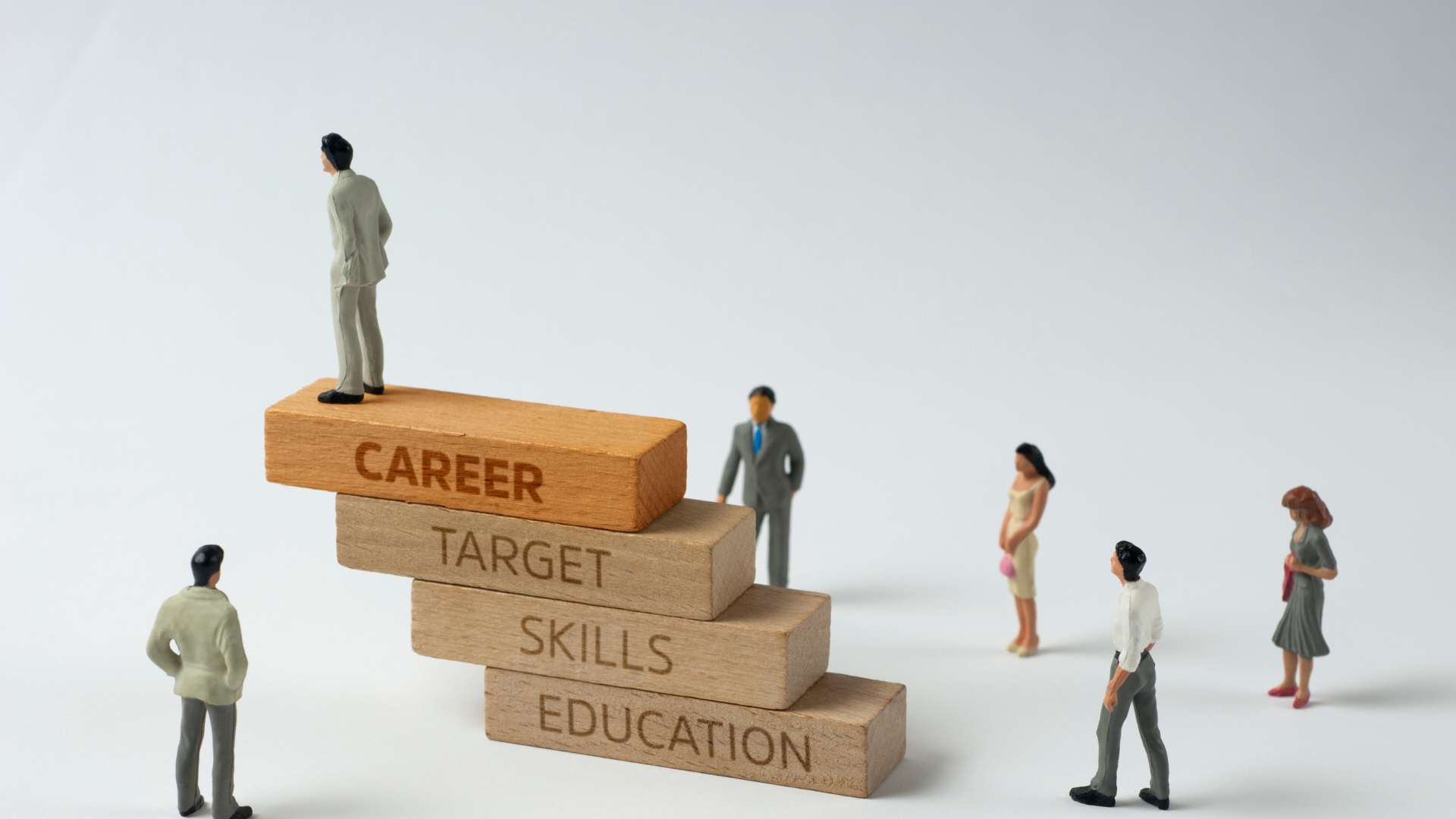 Wood blocks stacked like stairs that say career, target, skills, education