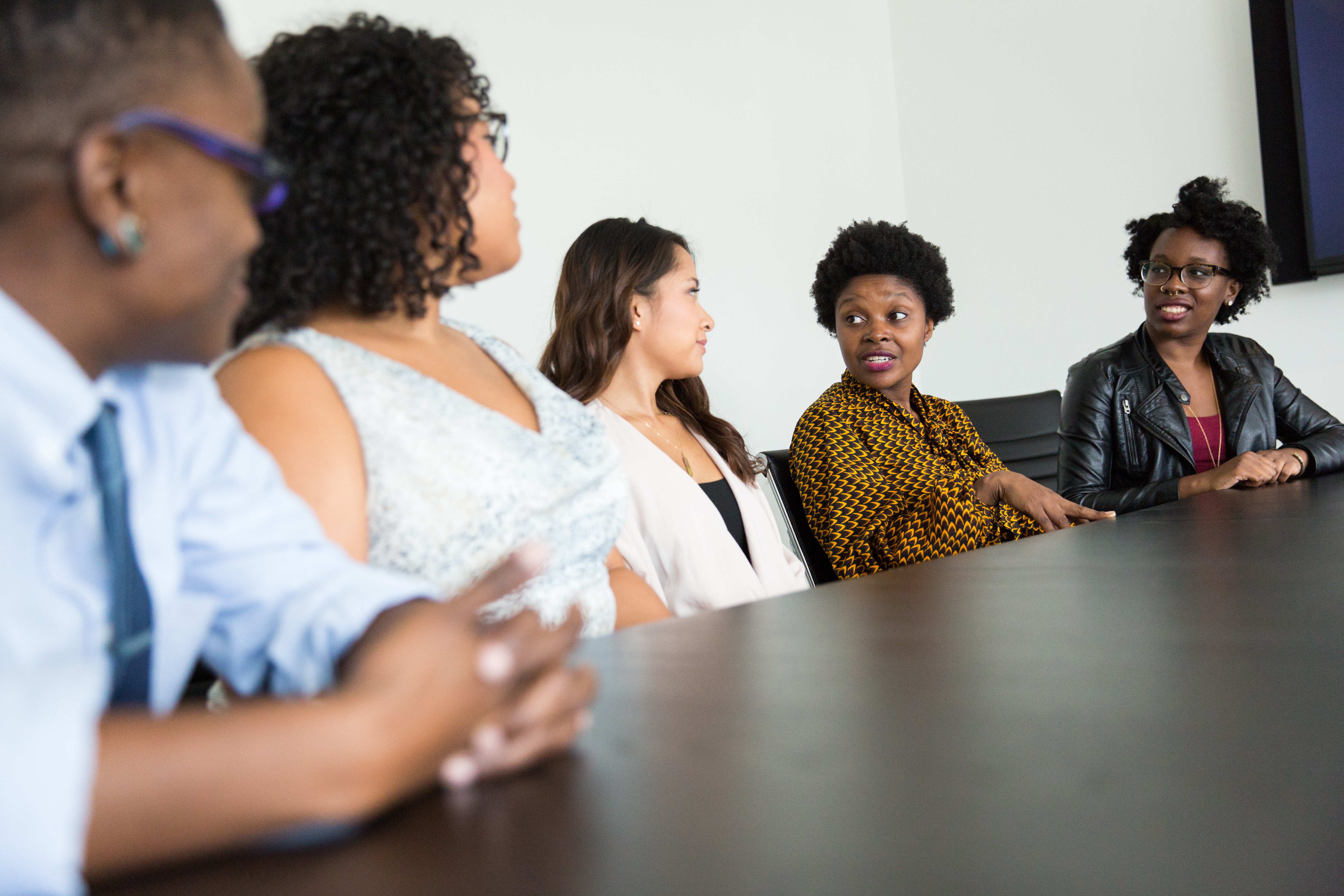 Group of people at a table discussing volunteer management at their nonprofit agency.
